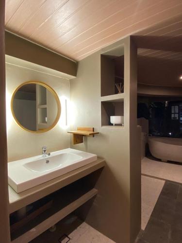 a bathroom with a sink and a mirror at NOBE Villas in Salakan
