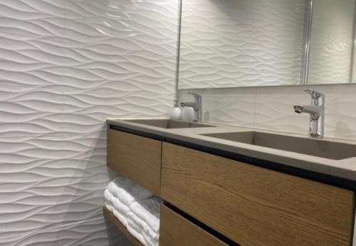 a bathroom with a sink and a mirror at Chalet Cosy in Pugny-Chatenod