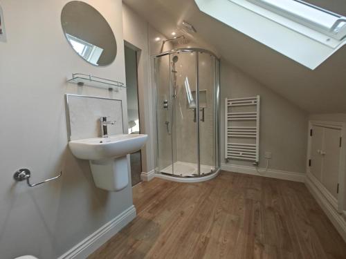 a bathroom with a shower and a sink and a mirror at 2 Bed in Castleton oc-p34012 in Castleton