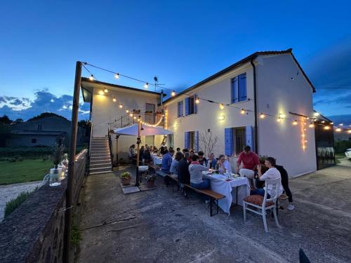 a group of people sitting at tables in front of a building at B&B Lilla All'Adige in Legnago