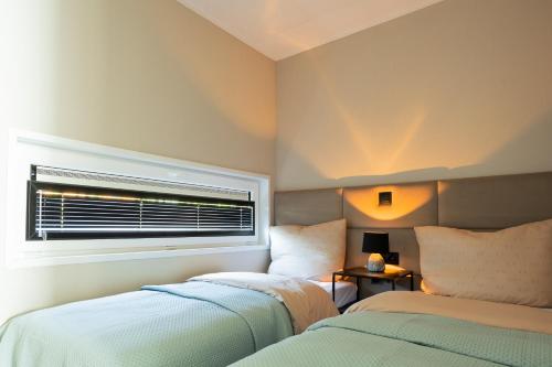 a bedroom with two beds next to a window at Mondri in Winterswijk