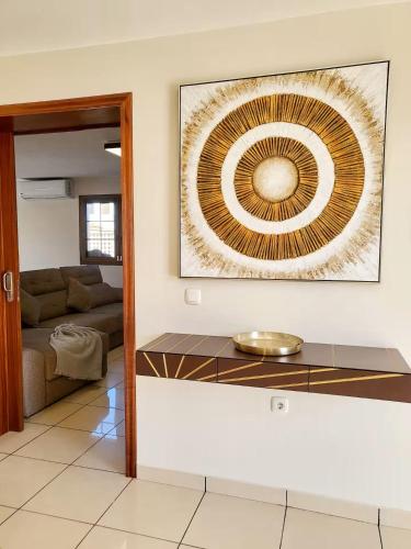 a living room with a painting on the wall at ENJOY House with Large Pool & Jacuzzi in Los Estancos