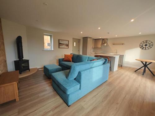 a living room with a blue couch and a kitchen at 2 Bed in Castleton oc-f34013 in Castleton