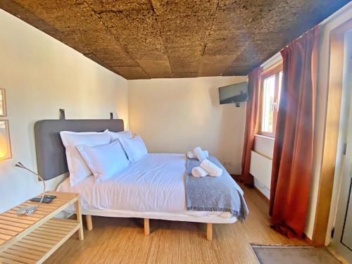a bedroom with a bed with a stuffed animal on it at Estúdio Charmoso no Coração das Termas in São Pedro do Sul