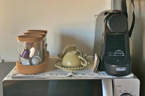 a counter top with a coffee pot and a toaster at Estúdio Charmoso no Coração das Termas in São Pedro do Sul