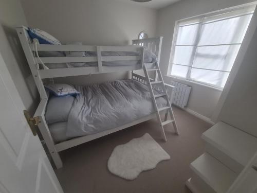 a bedroom with two bunk beds and a window at Clochan na Mara - Liscannor, County Clare & Wild Atlantic Way in Liscannor