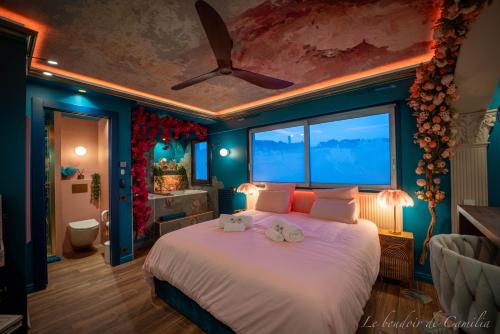 a bedroom with a large bed with a ceiling at Le Boudoir in Vallauris