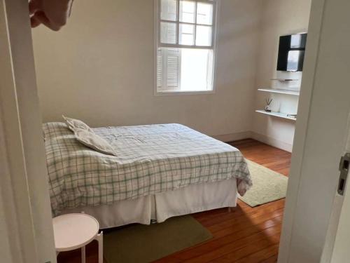 a small bedroom with a bed and a window at Casa Matias in Socorro