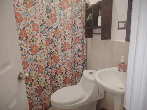 a bathroom with a toilet and a sink at Casa Socorrito in Ahuachapán