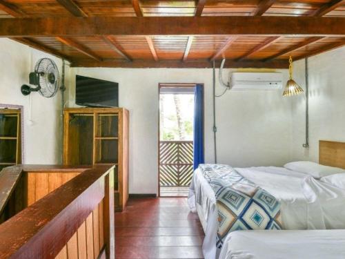 Giường trong phòng chung tại Lua Chalés