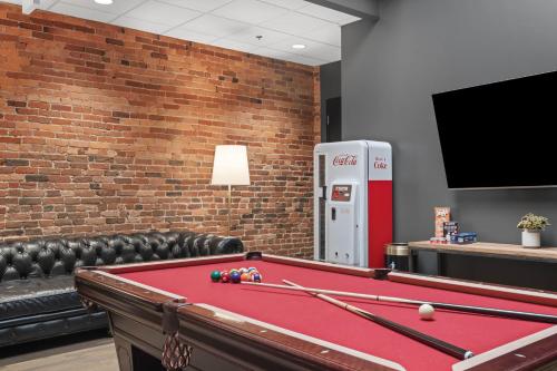 a room with a pool table and a soda machine at French's Luxury Condo - Steps from Broadway in Nashville
