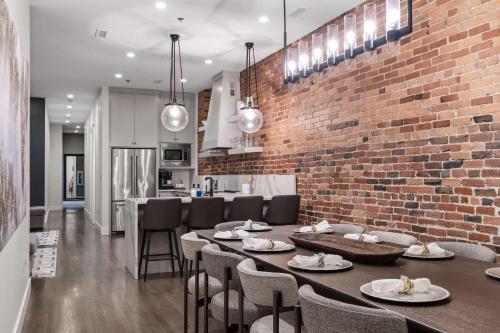 a kitchen and dining room with a brick wall at French's Luxury Condo - Steps from Broadway in Nashville