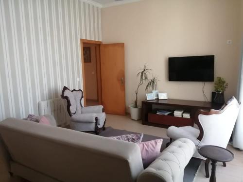 a living room with a couch and two chairs at CasAzulApartments in Sintra