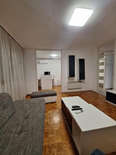 a living room with a couch and a table at San centar apartment in Banja Luka
