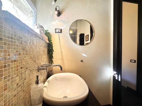 a bathroom with a white toilet and a mirror at LA COSTARELLA - Central with Cozy Terrace in Siena