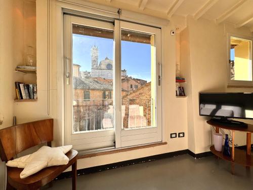 a room with a window with a view of the city at LA COSTARELLA - Central with Cozy Terrace in Siena