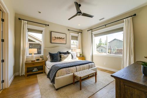 a bedroom with a bed and two windows at Hot Tub and Fire Pit Modern Flagstaff Home in Flagstaff
