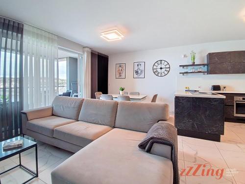 a living room with a couch and a table at St Paul's 3BR Apartment - Spectacular Sea Views in St. Paul's Bay