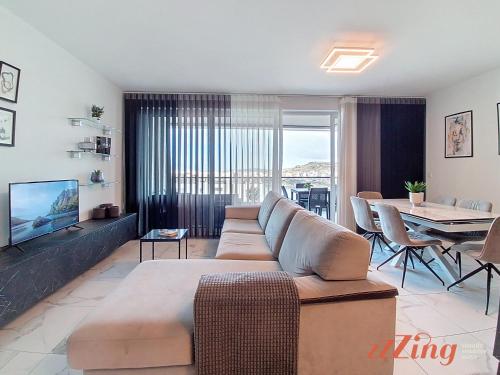 a living room with a couch and a table at St Paul's 3BR Apartment - Spectacular Sea Views in St. Paul's Bay