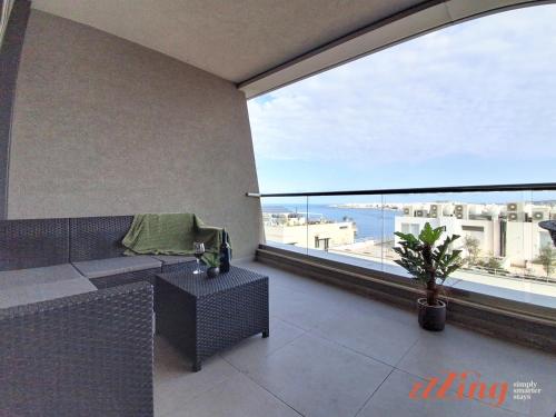 a room with a couch and a large window at St Paul's 3BR Apartment - Spectacular Sea Views in St. Paul's Bay