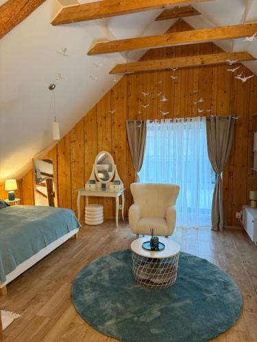 a bedroom with a bed and a chair in a room at Chata Lada Repechy in Bousín