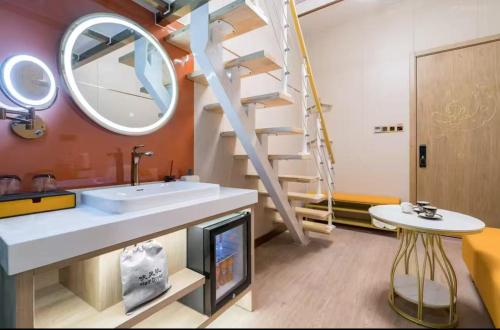 un baño con lavabo y espejo en Dequan Luxury Hotel National Exhibition Center Wangjing Bridge Branch The subway is right outside the door Coffee, snacks, a gym and a laundry room are provided for free in the lobby, en Beijing