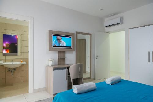 a bedroom with a bed and a tv on a wall at Hotel America in Scafati
