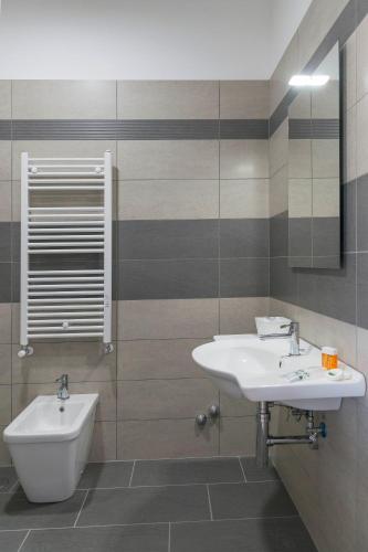 a bathroom with a sink and a toilet at Hotel America in Scafati