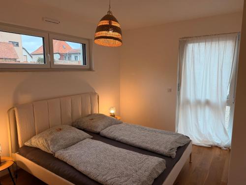 a bedroom with a bed and a large window at Gemütliches Wohnen in Worms