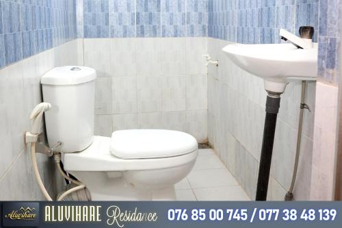 a bathroom with a toilet and a sink at Aluvihare Residence in Matale