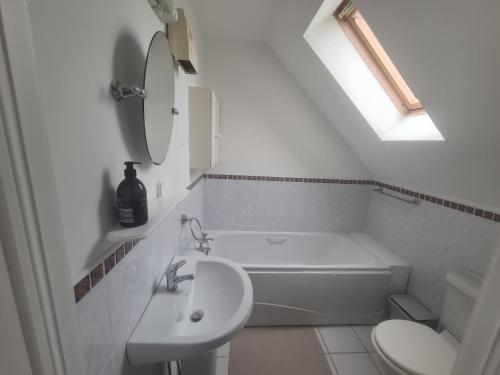 a white bathroom with a sink and a toilet at Clochan na Mara - Liscannor, County Clare & Wild Atlantic Way in Liscannor