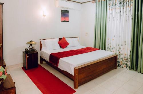 En eller flere senge i et værelse på Ocean Glow Ahungalla