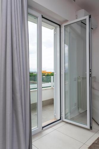 a room with sliding glass doors with a view at Hotel America in Scafati
