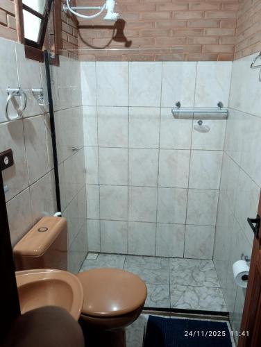 a bathroom with a shower and a toilet and a sink at Pousada Mar Azul in Trindade