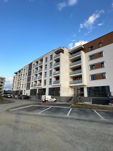 a parking lot in front of a large apartment building at Amber Central Residence in Baia Mare