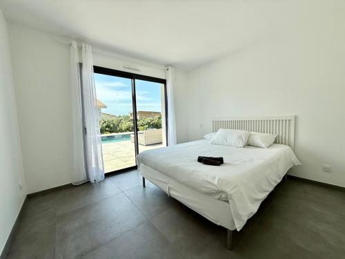 En eller flere senge i et værelse på Villa Aurora Piscine 7 personnes