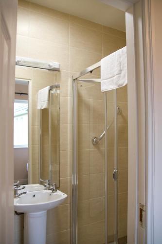 a bathroom with a sink and a shower at Atlantic View Cottages in Doolin