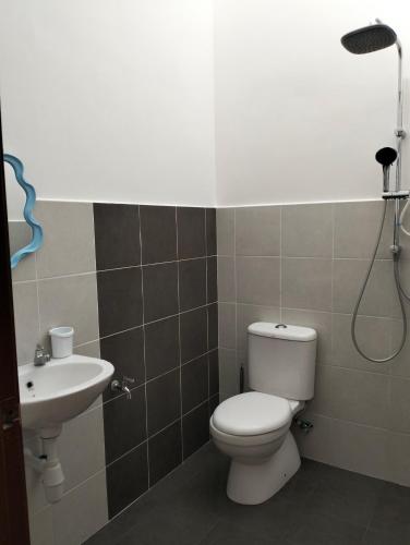 a bathroom with a toilet and a sink at Betta Imbellis Stay in Kesang Pajak