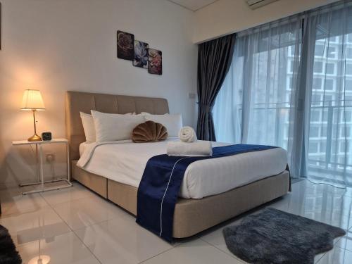 a bedroom with a large bed and a large window at Summer suites Klcc 8 min walk Free Netflix and WiFi by AA GLOBAL in Kuala Lumpur