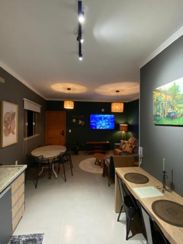 uma sala de estar com um sofá e uma mesa em Duas Suites aconchegantes em frente a Montanha em Poços de Caldas