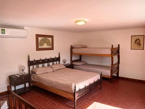 a bedroom with two beds and a bunk bed at Depto 1615 in Villa Mercedes