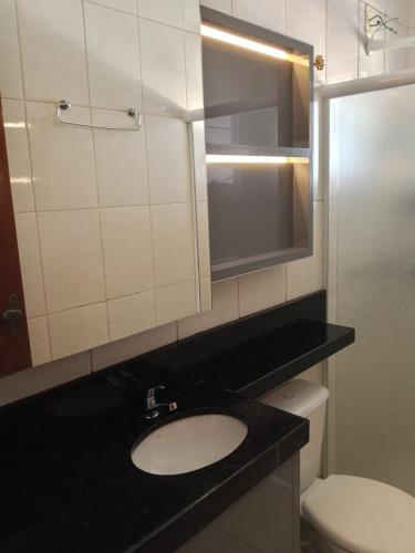 a bathroom with a sink and a toilet at Seu lar em Cascavel in Cascavel
