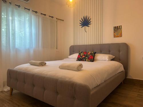 a bed with two pillows on it in a bedroom at Lady of the DeadSea Crown Group Collection in Neve Zohar