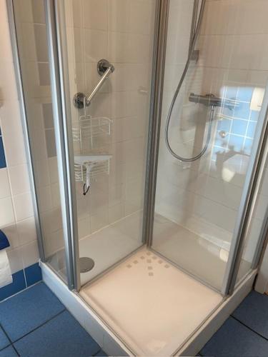 a shower with a glass door in a bathroom at Seestr 75 a Haus A links in Zingst