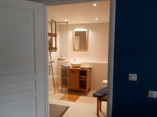 a bathroom with a sink and a mirror at La Longère d'Arzoù Chambres D'hôtes in Mériadec