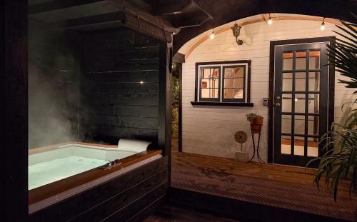 a bathroom with a bath tub with smoke in it at The Cabana Luxury Award Winning Tiny Home with Hot Tub and Private Garden 2 mins Walk to Ryde Beach in Ryde
