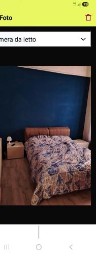 a picture of a bedroom with a bed with a blue wall at casa adriana in Taranto