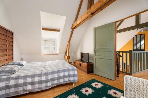 Un dormitorio con una cama y una puerta verde. en Gîte du 17 - bien-être avec spa, en Trans