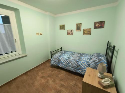 a bedroom with a bed and a table and a window at Casa Vacanze da Nonna Chiarina in Anagni