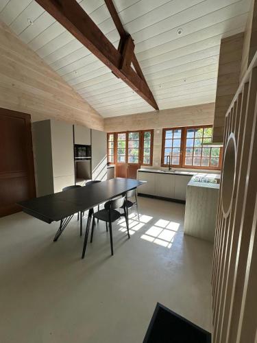 a large room with a table and chairs in it at Le Refuge du Pyla in La Teste-de-Buch